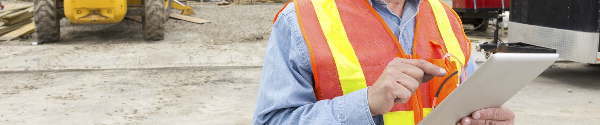 A royalty free image from the construction industry of a construction worker at a new home building site.